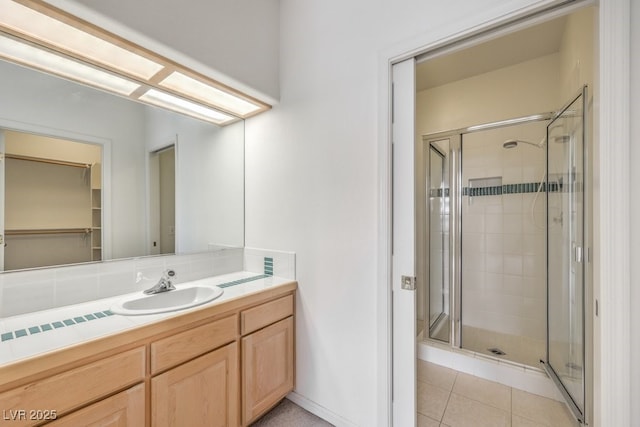 bathroom featuring vanity, tile patterned floors, and a stall shower