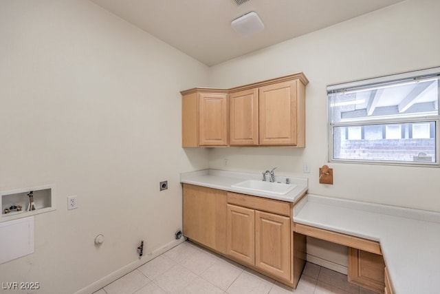 clothes washing area with washer hookup, a sink, hookup for a gas dryer, light tile patterned floors, and hookup for an electric dryer