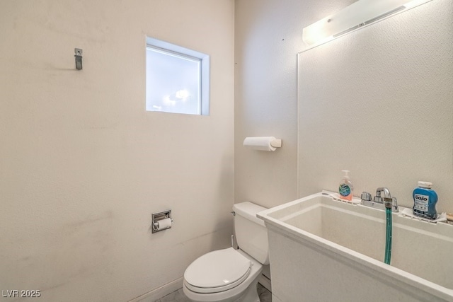 bathroom featuring toilet and a sink