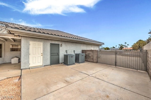 view of patio featuring a gate, central AC, and fence