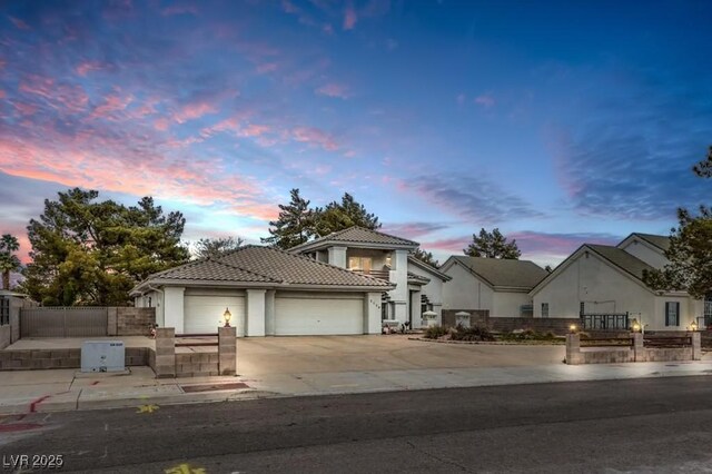 3710 E Oquendo Rd, Las Vegas, NV 89120 - view of front of house with a tiled roof, an attached garage, concrete driveway, and stucco siding