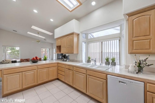 3710 E Oquendo Rd, Las Vegas, NV 89120 - kitchen with dishwasher, a sink, light brown cabinetry, vaulted ceiling, and a peninsula