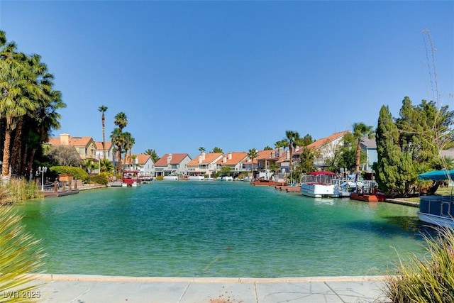 view of water feature with a residential view and a boat dock