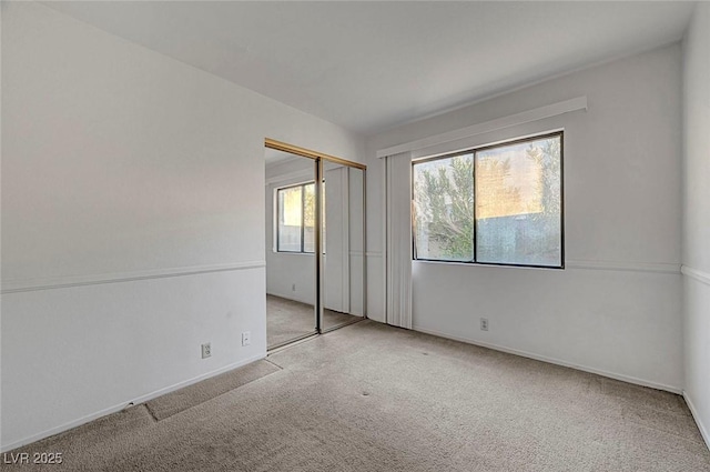 unfurnished room featuring baseboards and carpet floors