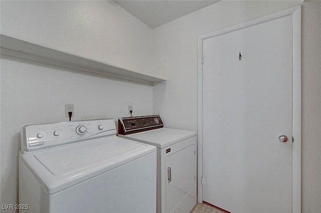 washroom featuring laundry area, washing machine and dryer, and light floors