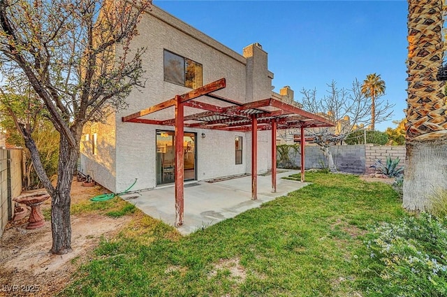 back of house featuring stucco siding, a pergola, a fenced backyard, a yard, and a patio area