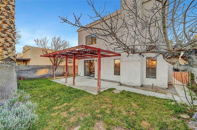 back of property with a patio, a lawn, a fenced backyard, and a pergola