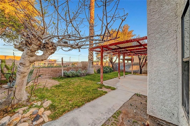 view of yard with fence private yard, a pergola, and a patio