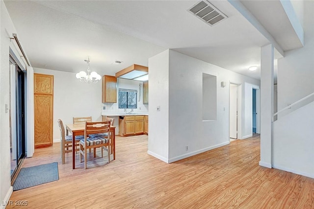 dining space with visible vents, baseboards, light wood-style floors, and a notable chandelier