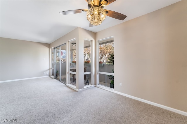 empty room featuring a ceiling fan, a healthy amount of sunlight, baseboards, and carpet floors