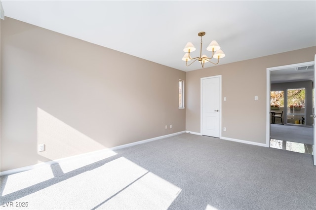 spare room with baseboards, carpet floors, visible vents, and a chandelier