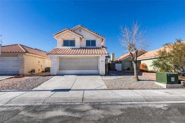 mediterranean / spanish-style house featuring cooling unit, driveway, a tile roof, and stucco siding