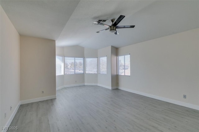 empty room with a ceiling fan, light wood-style floors, and baseboards