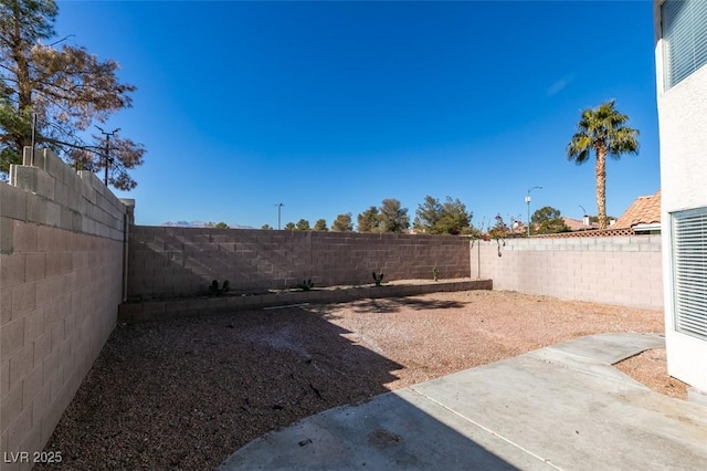 view of yard featuring a patio and a fenced backyard