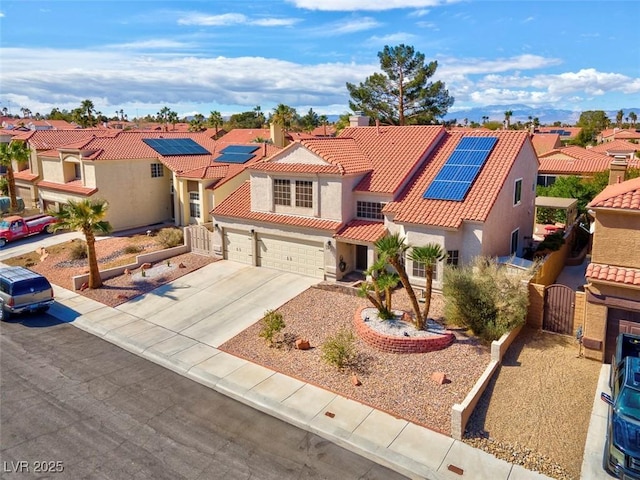 view of front of property with a tiled roof, a residential view, stucco siding, and a gate