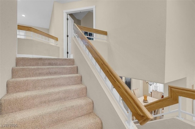 staircase featuring recessed lighting