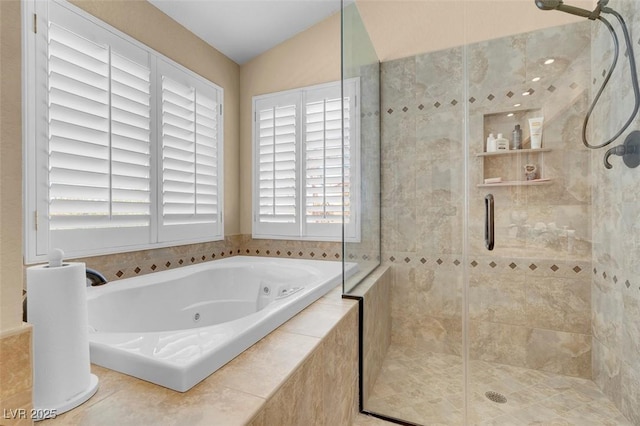 bathroom featuring a jetted tub, a shower stall, and vaulted ceiling