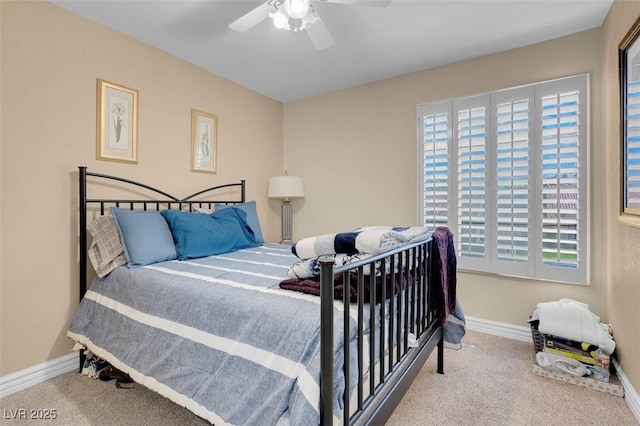 carpeted bedroom featuring baseboards and ceiling fan