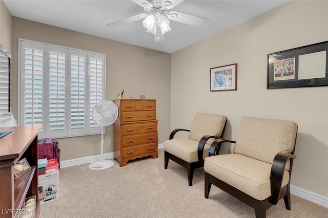 sitting room with baseboards, carpet floors, and a ceiling fan