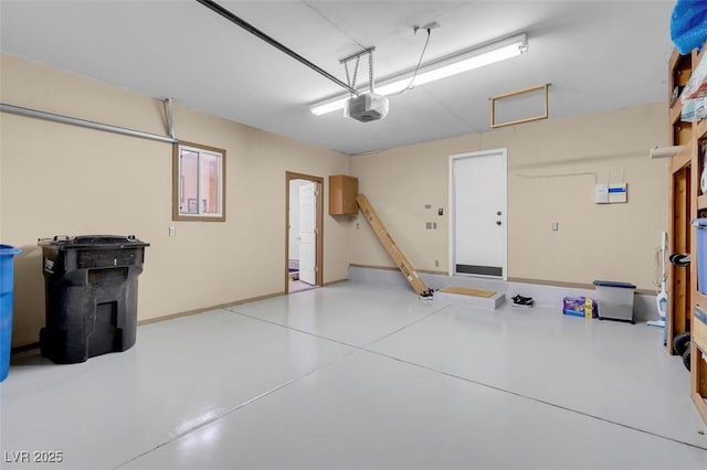 garage with baseboards and a garage door opener