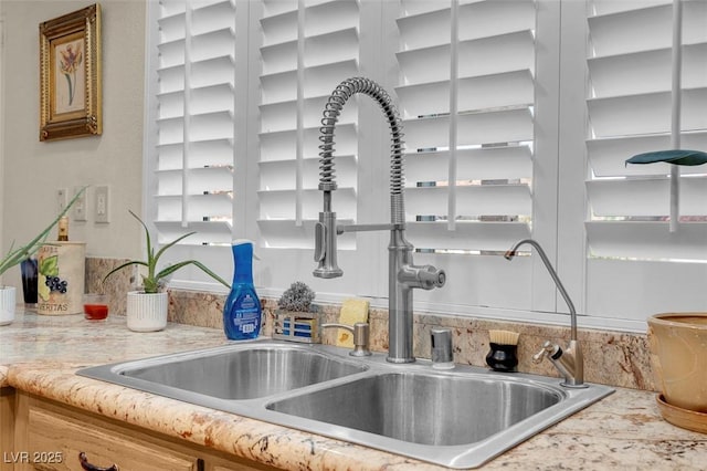details featuring a sink and light countertops