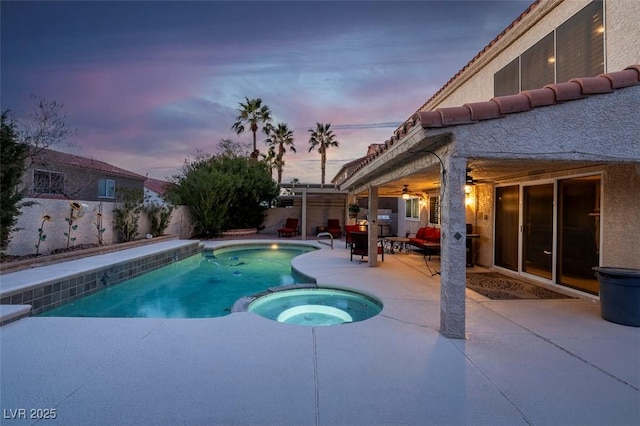 view of pool with a pool with connected hot tub, a patio area, a fenced backyard, and ceiling fan