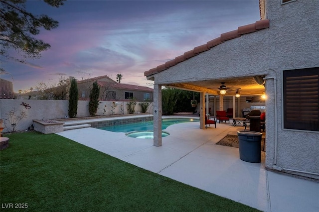 pool at dusk with a patio, a fenced in pool, a yard, a fenced backyard, and ceiling fan