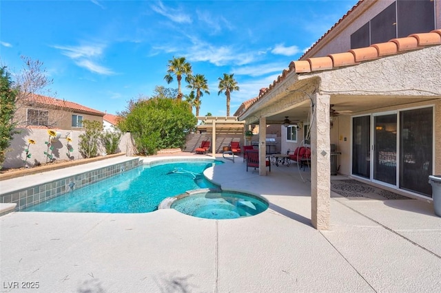 view of swimming pool with a fenced backyard, ceiling fan, a pool with connected hot tub, and a patio