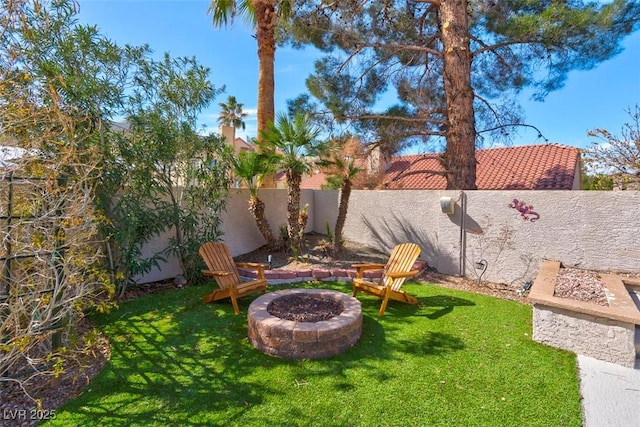 view of yard featuring a fire pit and a fenced backyard