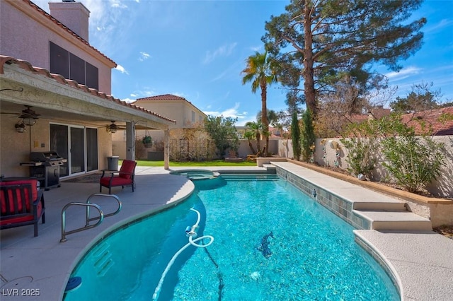 view of swimming pool featuring grilling area, a pool with connected hot tub, ceiling fan, a fenced backyard, and a patio