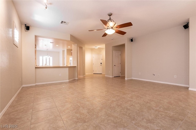 unfurnished living room featuring light tile patterned flooring, visible vents, baseboards, and ceiling fan