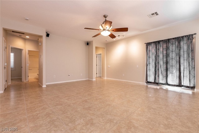 empty room featuring visible vents, baseboards, and ceiling fan