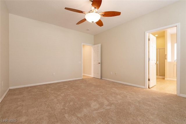 unfurnished room featuring a ceiling fan, light colored carpet, and baseboards