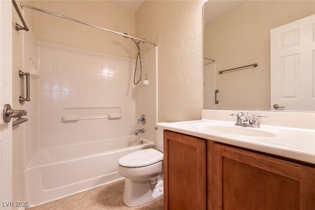 bathroom with tile patterned flooring, toilet, shower / tub combination, a textured wall, and vanity