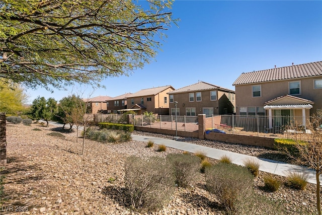 view of home's community with fence and a residential view