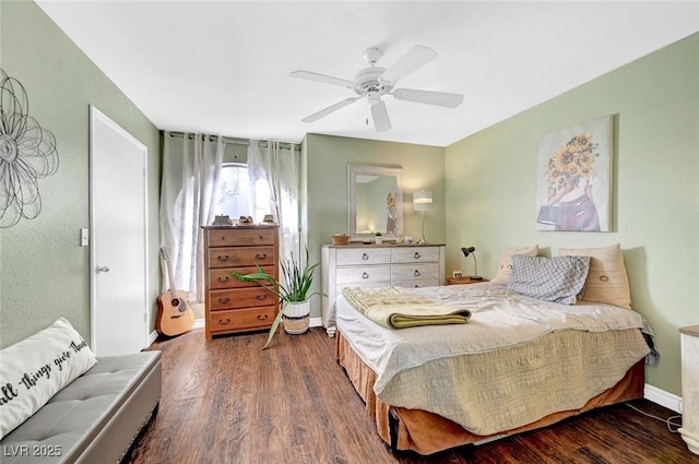 bedroom featuring a ceiling fan, wood finished floors, and baseboards