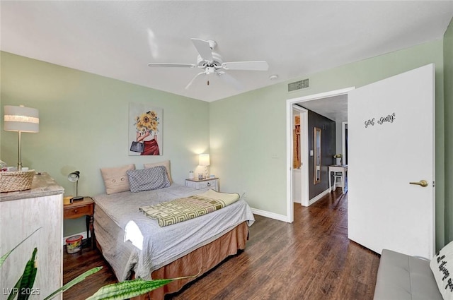 bedroom featuring visible vents, ceiling fan, baseboards, and wood finished floors