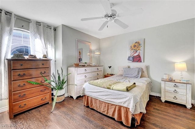 bedroom featuring baseboards, ceiling fan, and dark wood-style flooring