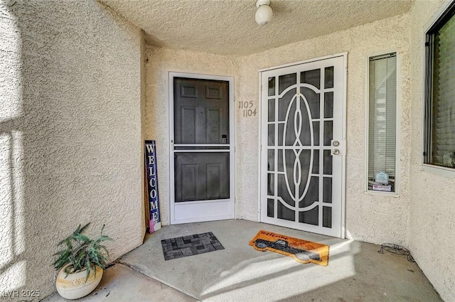 doorway to property with stucco siding