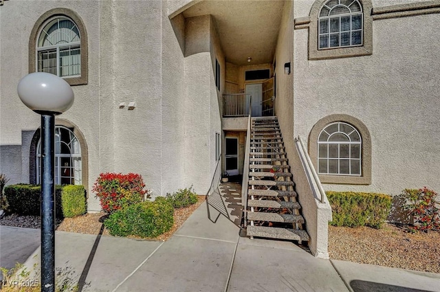 view of exterior entry with stucco siding