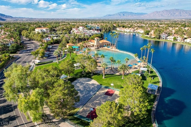 drone / aerial view featuring a water and mountain view