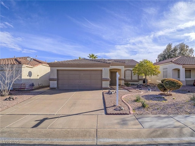 mediterranean / spanish house featuring stucco siding, a garage, concrete driveway, and a tile roof