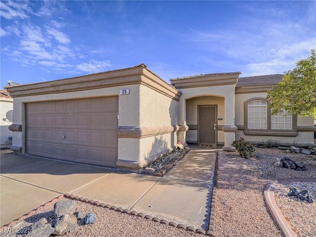 view of front of home featuring stucco siding and concrete driveway