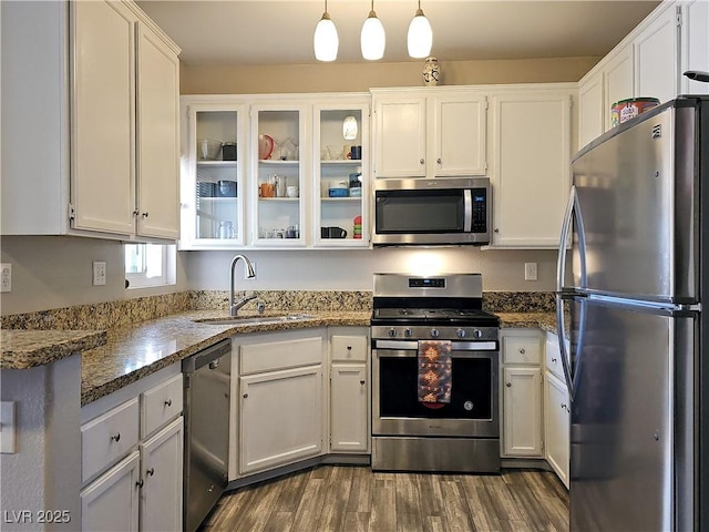 kitchen with a sink, dark wood-style floors, white cabinetry, and stainless steel appliances