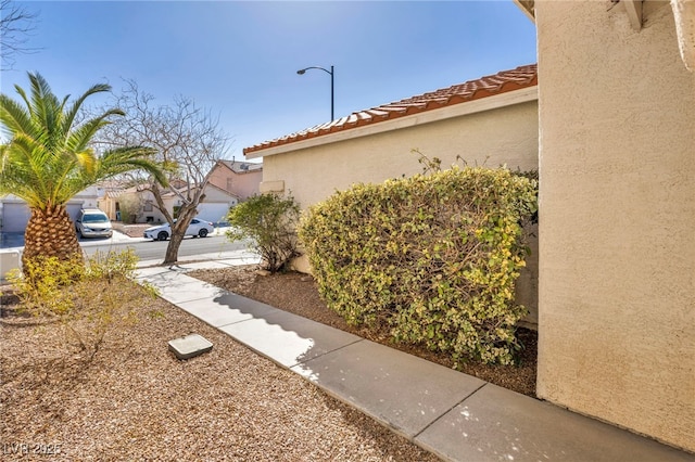 view of home's exterior featuring stucco siding and a tile roof