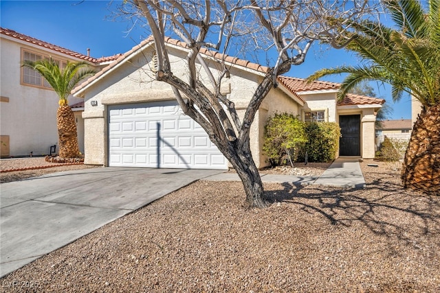 mediterranean / spanish house featuring stucco siding, driveway, a tile roof, and a garage