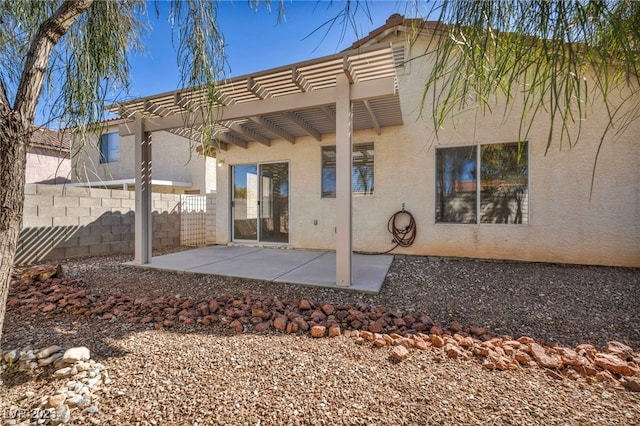 back of house with a patio area, fence, a pergola, and stucco siding