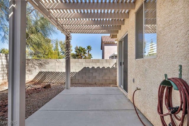 view of patio featuring fence