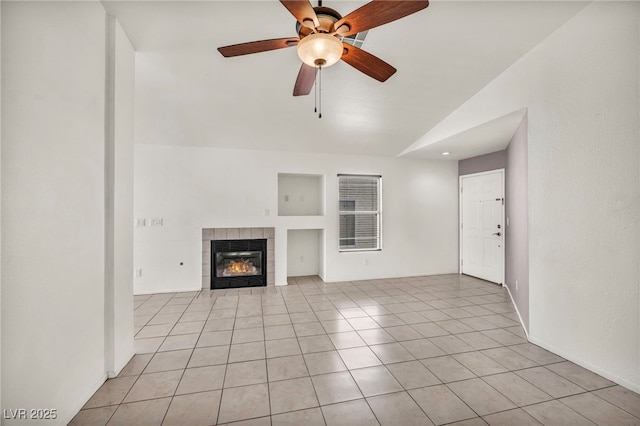 unfurnished living room with light tile patterned flooring, a fireplace, a ceiling fan, and vaulted ceiling