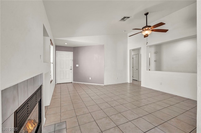 unfurnished living room featuring visible vents, baseboards, light tile patterned flooring, high vaulted ceiling, and a ceiling fan